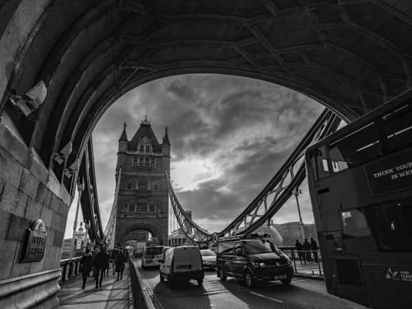 grayscale photo of cars on bridge